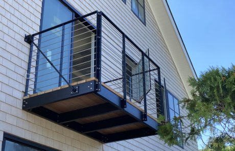 suspended balcony with solid stainless steal rod railing and mahogany floor